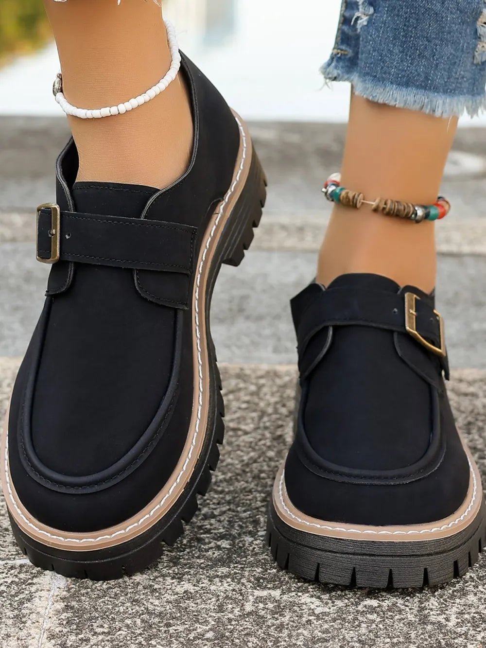 Buckle detail on classic loafers
Side view of leather loafers