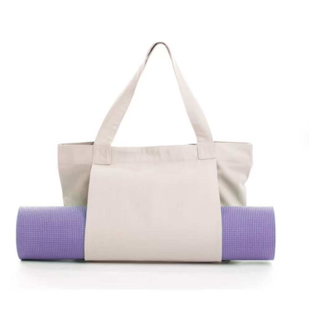 Woman carrying yoga bag to fitness class