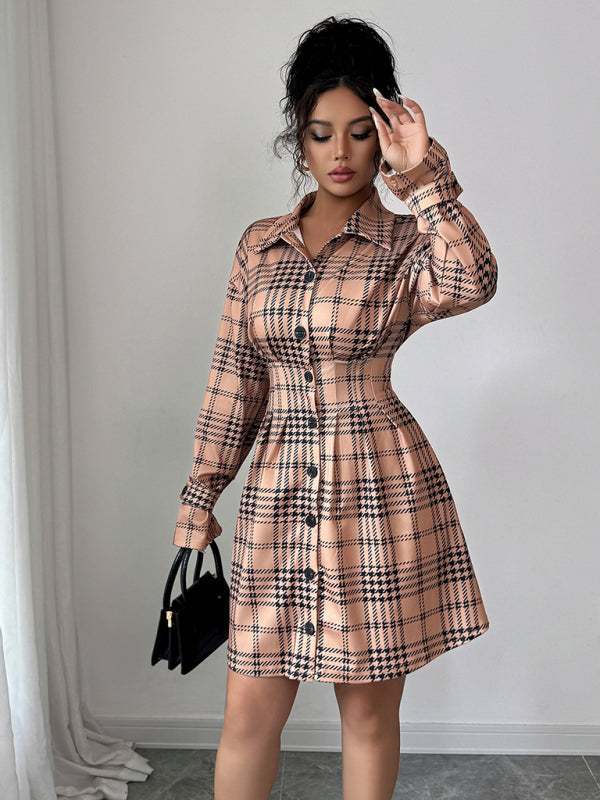Woman wearing a plaid dress with a plain background