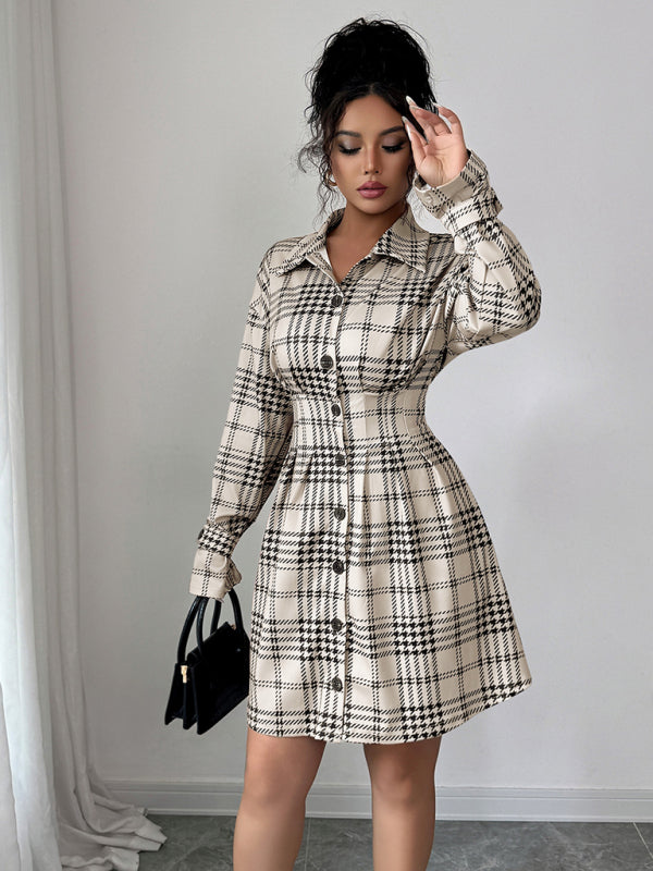 Woman wearing a plaid dress with a plain background