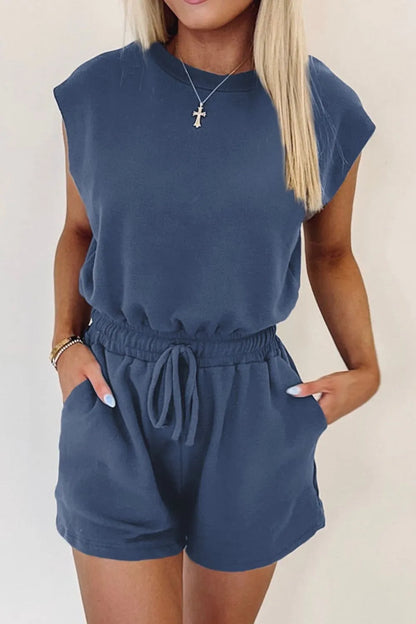 Woman wearing a casual round neck romper with drawstring waist

