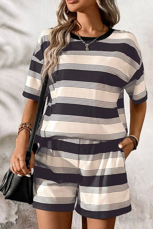 Woman wearing a black and white striped two-piece loungewear set with short sleeves and shorts

-Max