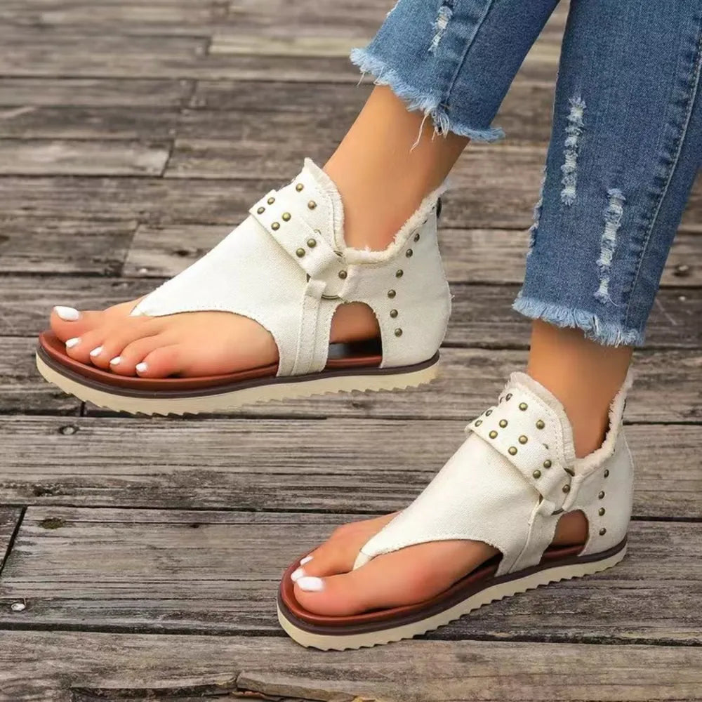 Side view of studded flat summer shoes

