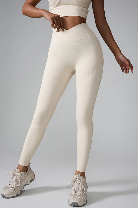 "Cream ribbed high-waisted leggings with matching sports bra and chunky sneakers"
