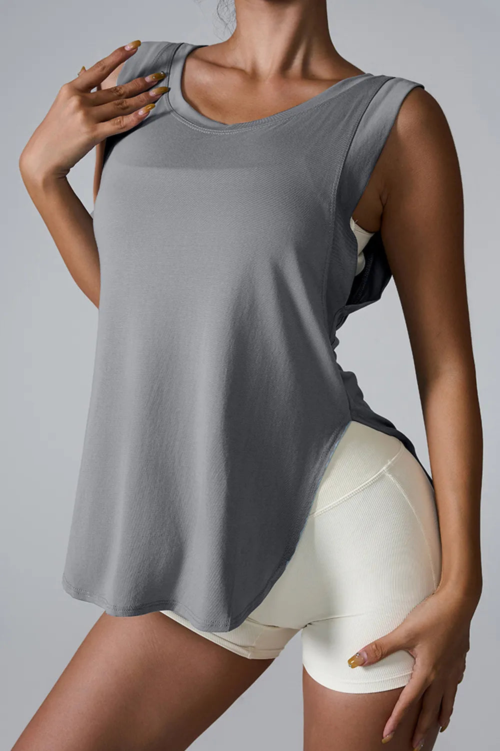 "Lightweight white exercise tank with functional side slit design"

