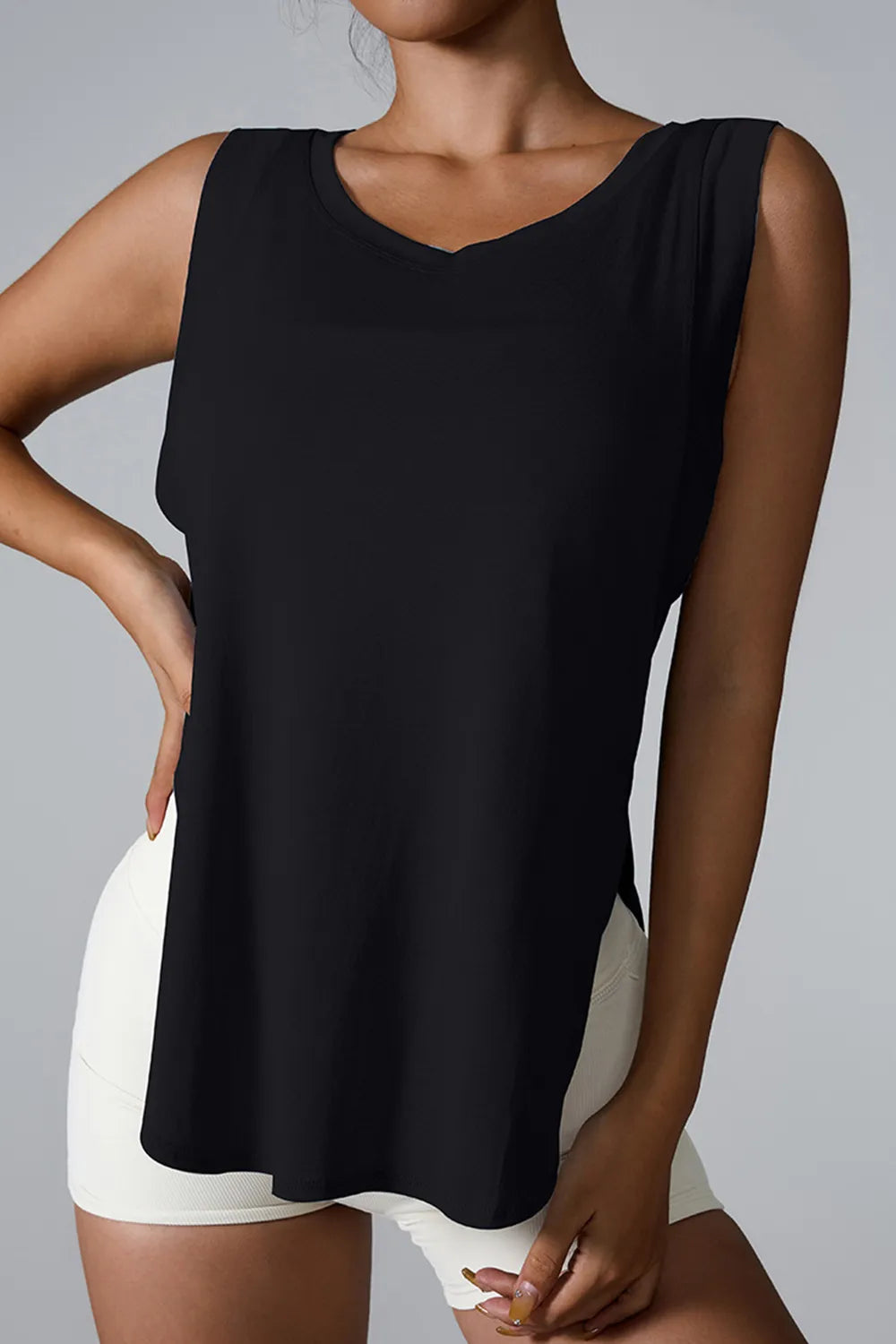 "Casual white workout tank featuring side slit detail and scoop neck"
