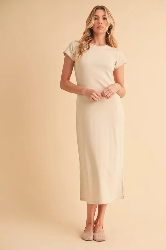 Woman wearing beige short sleeve dress standing against a neutral background
-Max-Origin