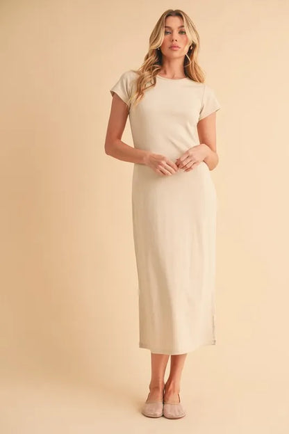 Woman wearing beige short sleeve dress standing against a neutral background
-Max-Origin