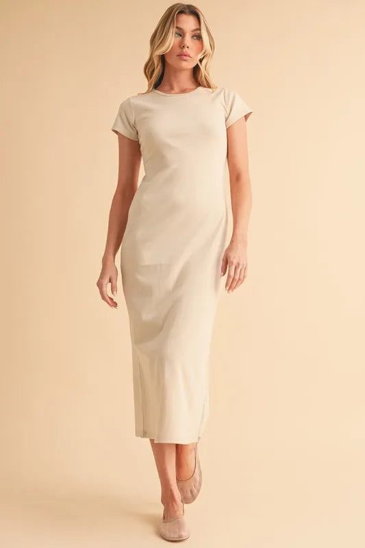 wearing beige short sleeve maxi dress standing against a neutral background
-Max-Origin