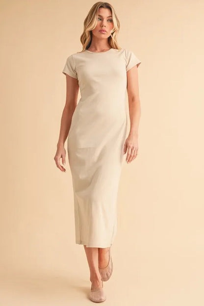 wearing beige short sleeve maxi dress standing against a neutral background
-Max-Origin