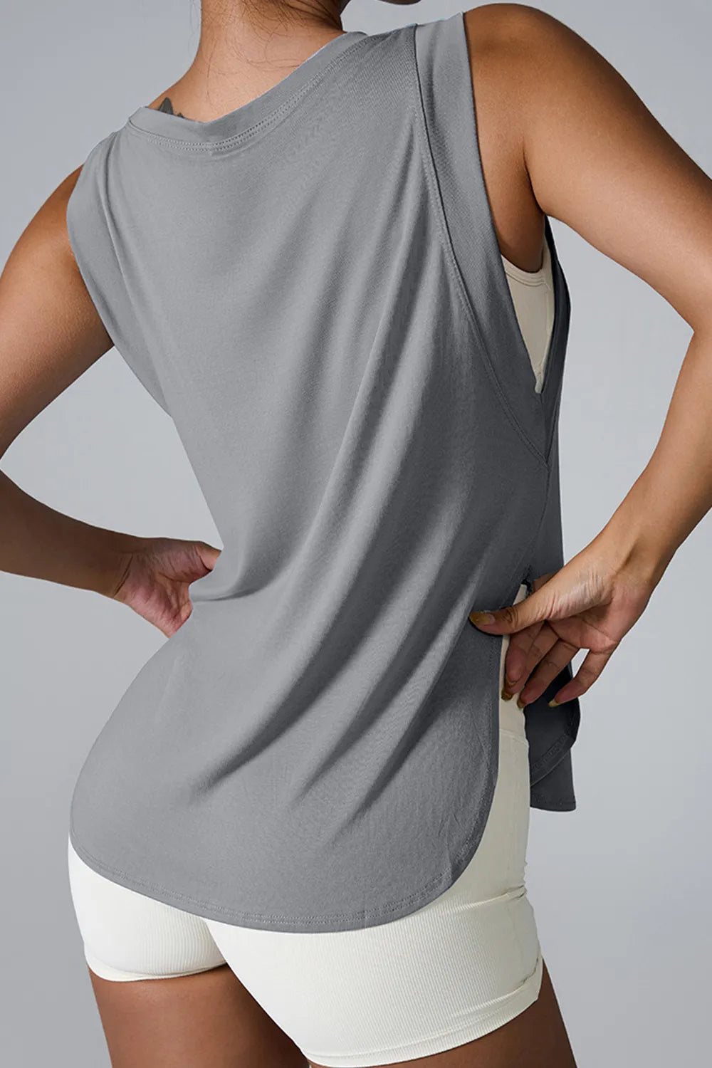 "Modern white workout top with flow-enhancing side detail"
