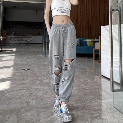 Woman wearing gray ripped jogger sweatpants with casual streetwear style
great
