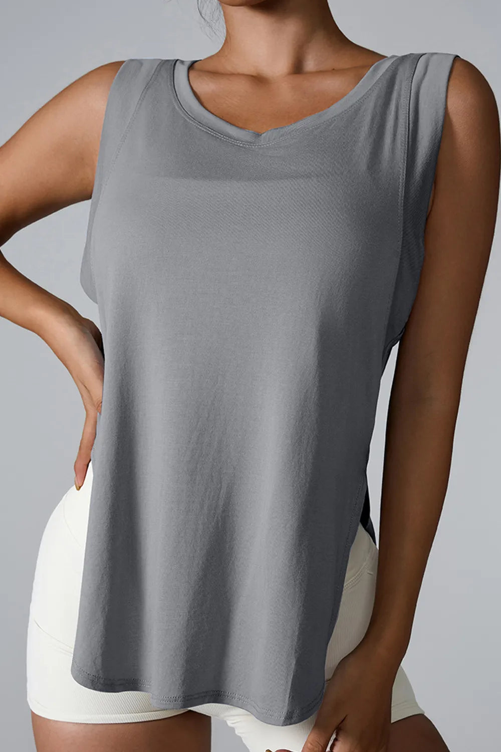 "Comfortable white athletic tank top with side detail for enhanced movement"
