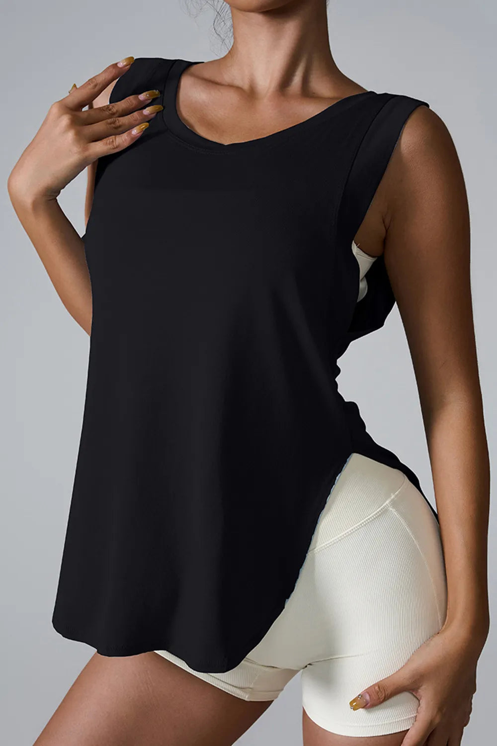 "Minimalist white athletic tank with relaxed fit and olive leggings"
