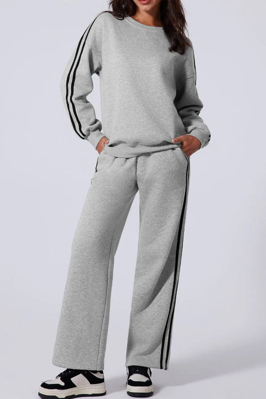 Woman wearing a side striped round neck top and pants active set

