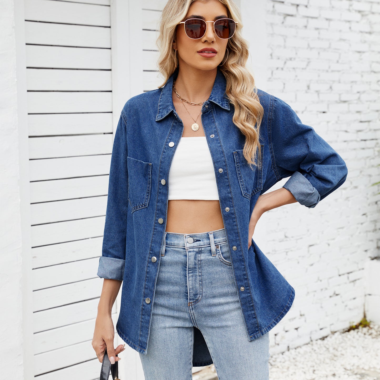 Model wearing denim shirt tucked into jeans


