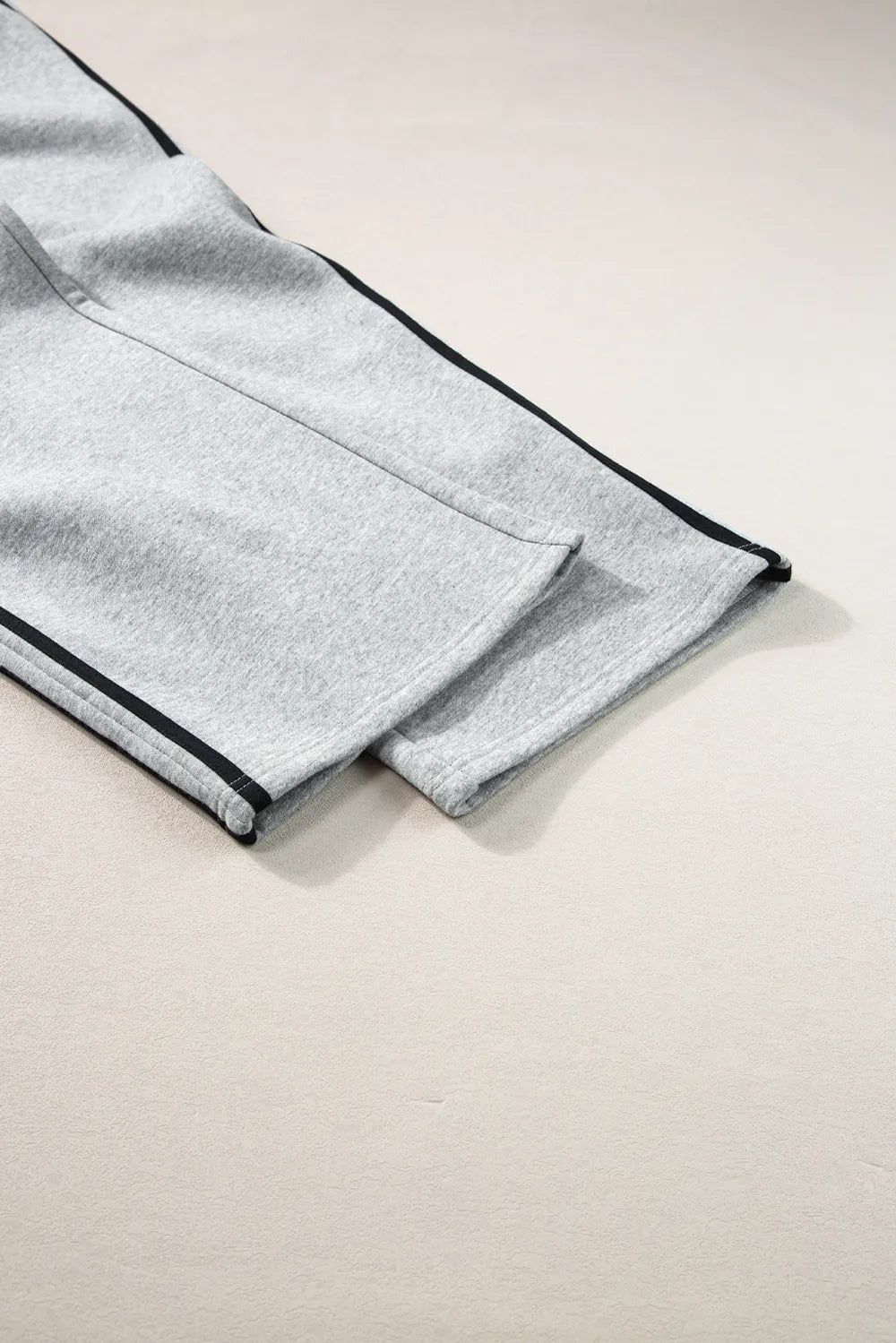 Matching two-piece activewear outfit in solid color with contrast stripes

