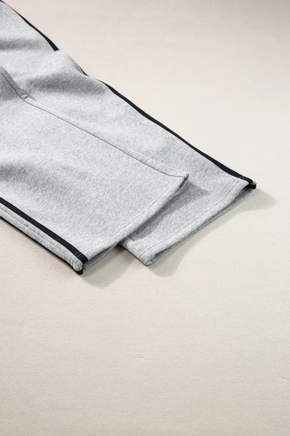 Matching two-piece activewear outfit in solid color with contrast stripes

