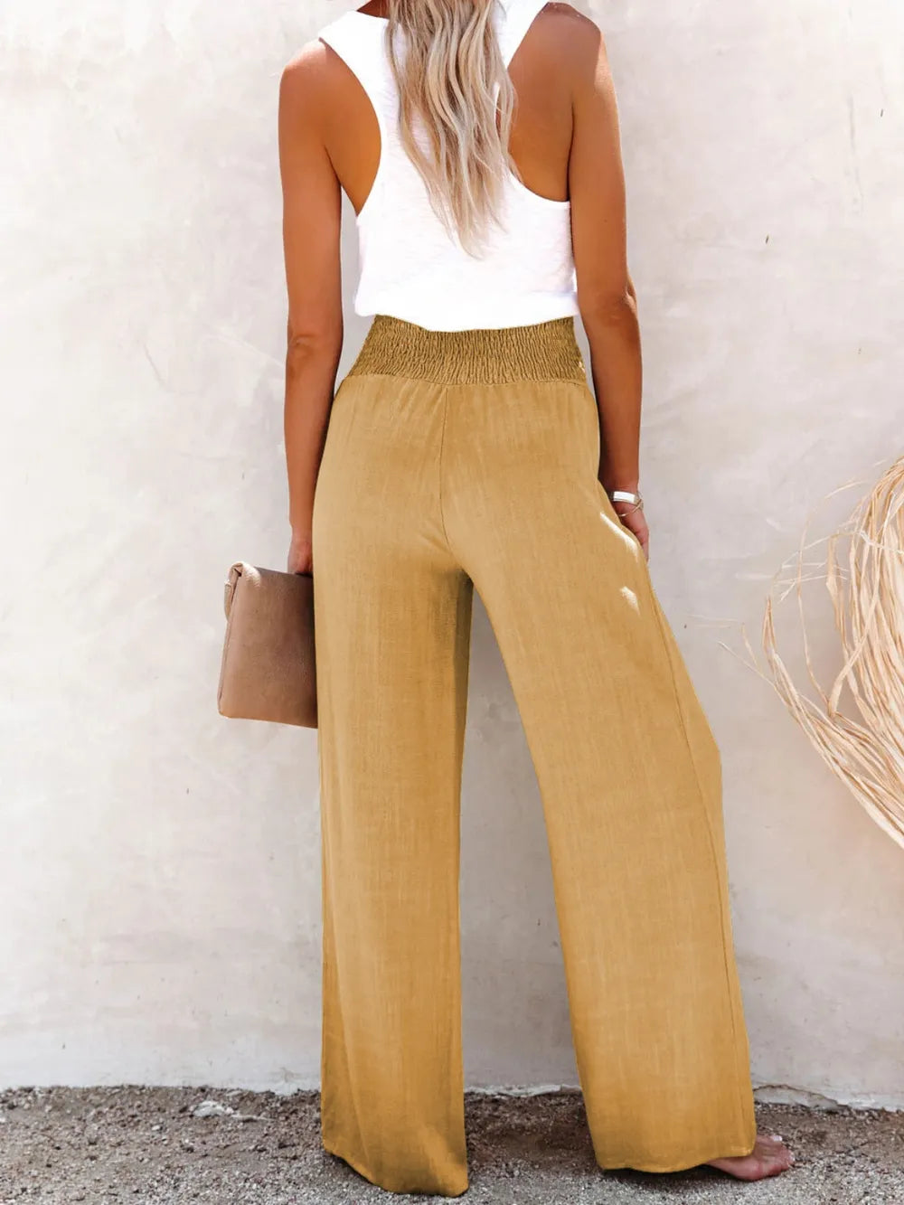 Close-up of decorative buttons on high waist pants
