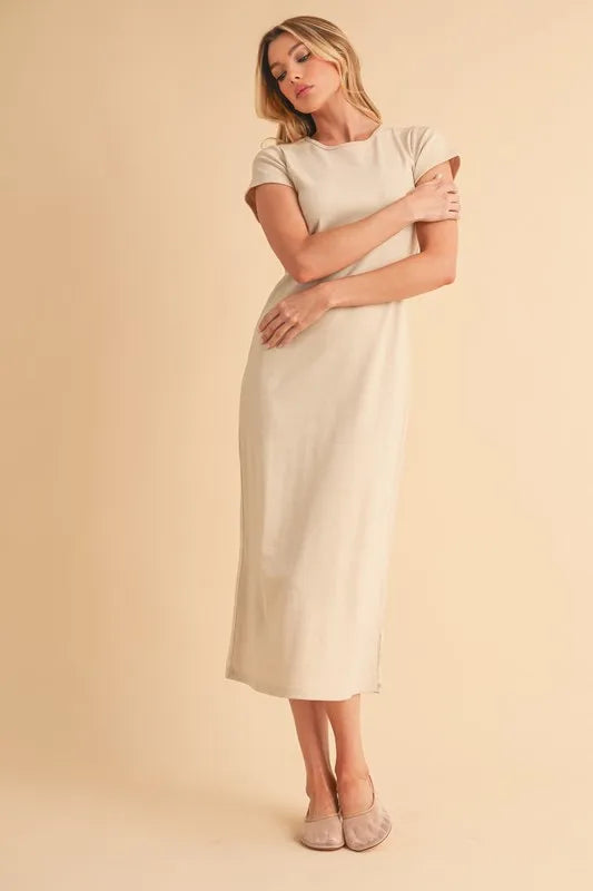 Woman wearing beige short sleeve maxi dress standing against a neutral background
Max-Origin