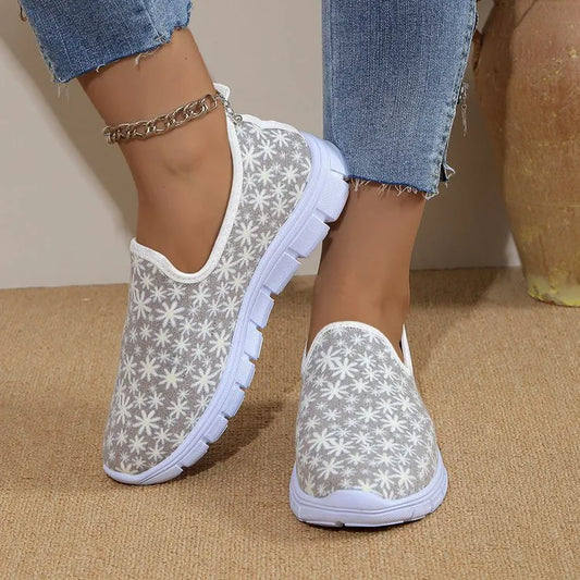 Woman wearing floral mesh slip-on sneakers – side view