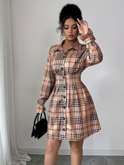 Woman wearing a plaid dress with a plain background
