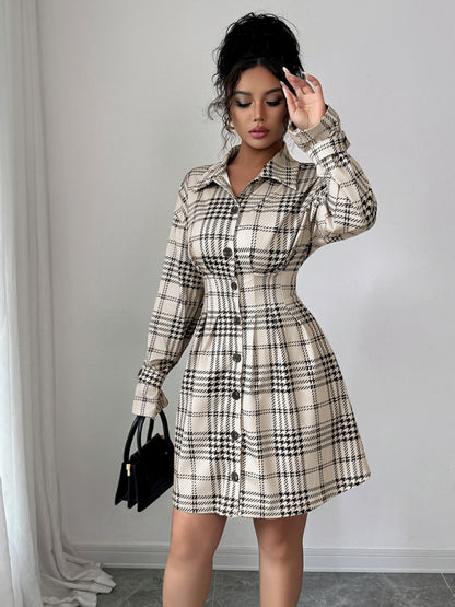 Woman wearing a plaid dress with a plain background