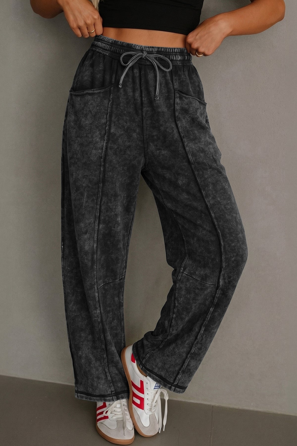 Women's black mineral wash raw seam drawstring barrel pants by Mazify