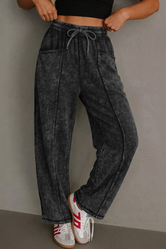 Women's black mineral wash raw seam drawstring barrel pants by Mazify