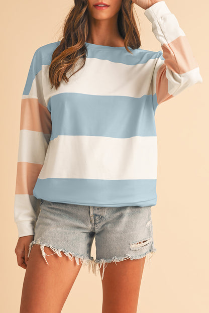 woman wearing pastel blue colorblock long sleeve casual top