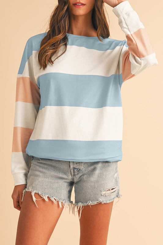 woman wearing pastel blue colorblock long sleeve casual top