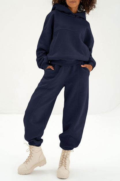 Women's navy blue oversized hoodie and matching jogger pants tracksuit activewear set with exposed seam detail