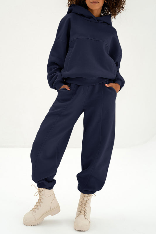 Women's navy blue oversized hoodie and matching jogger pants tracksuit activewear set with exposed seam detail
