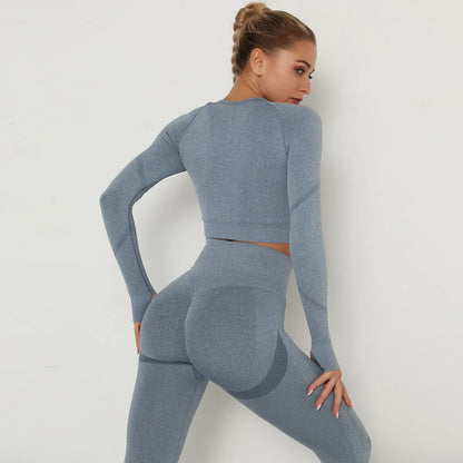 Women's blue seamless long sleeve crop top and scrunch booty leggings gym set back view